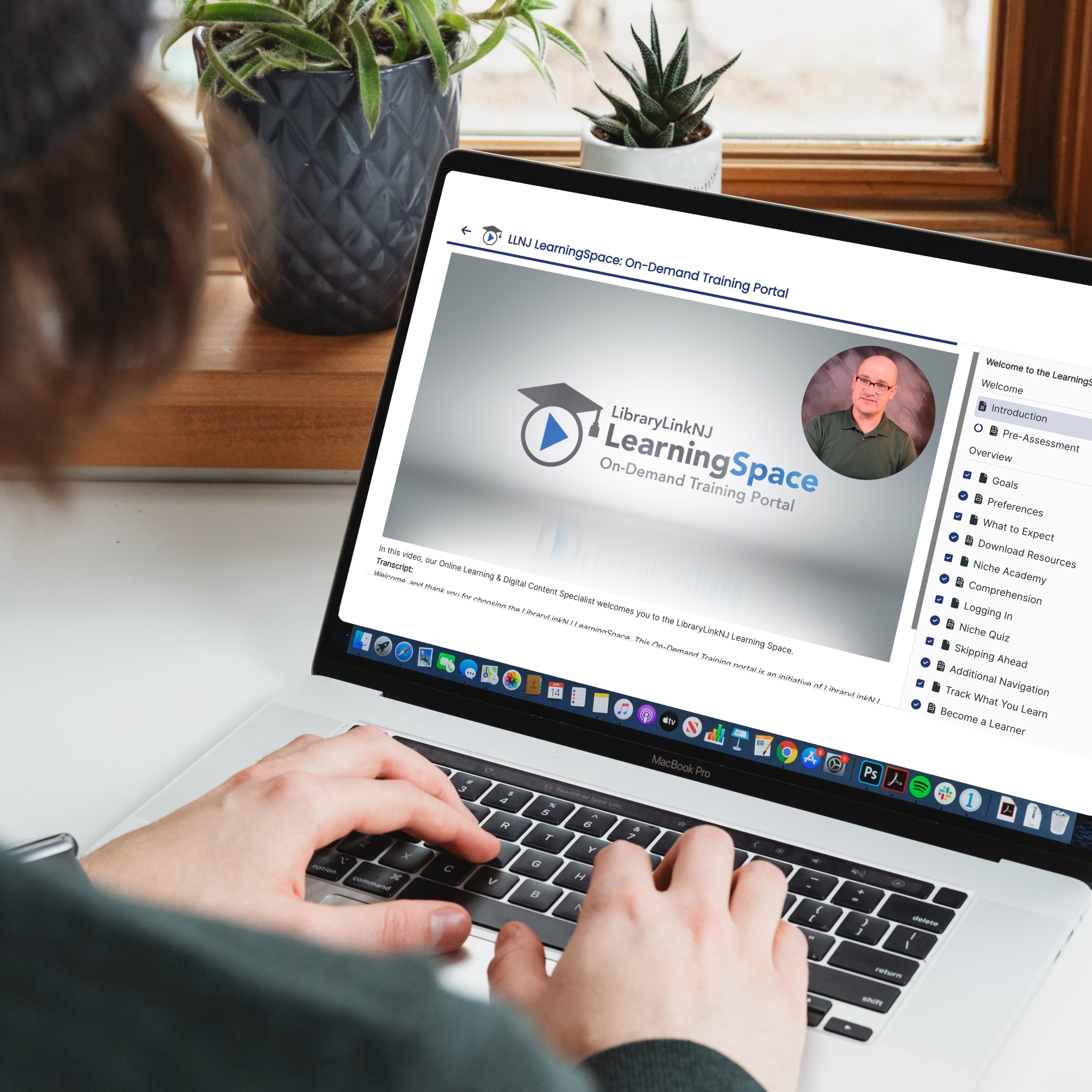 A person types on a laptop while viewing the LearningSpace.