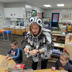 Cathy Black, from Orena Humphreys Pubic Library, working with pre-school students to make an owl hand puppet during story time at the Whitwell Head Start center